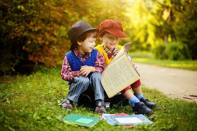 Kids Magazines That Will Captivate Your Classroom 1 Kids reading kids magazines outdoors.
